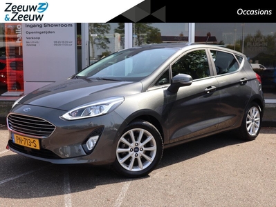 Ford Fiesta 1.0 EcoBoost Titanium | Adaptieve Cruise Control | Trekhaak | Voorruitverwarming | Camera | B&O | Navigatie | Parkeersensoren | Climate Control | Lane Keeping Aid | All Weather Banden